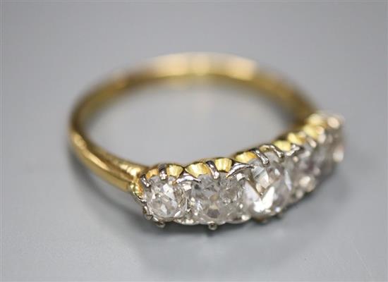 An 18ct gold and diamond five-stone ring, size L/M, gross 3 grams.